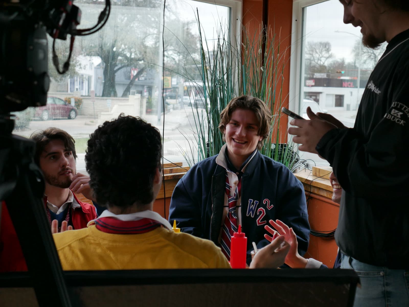 Actors share a diner booth during a take