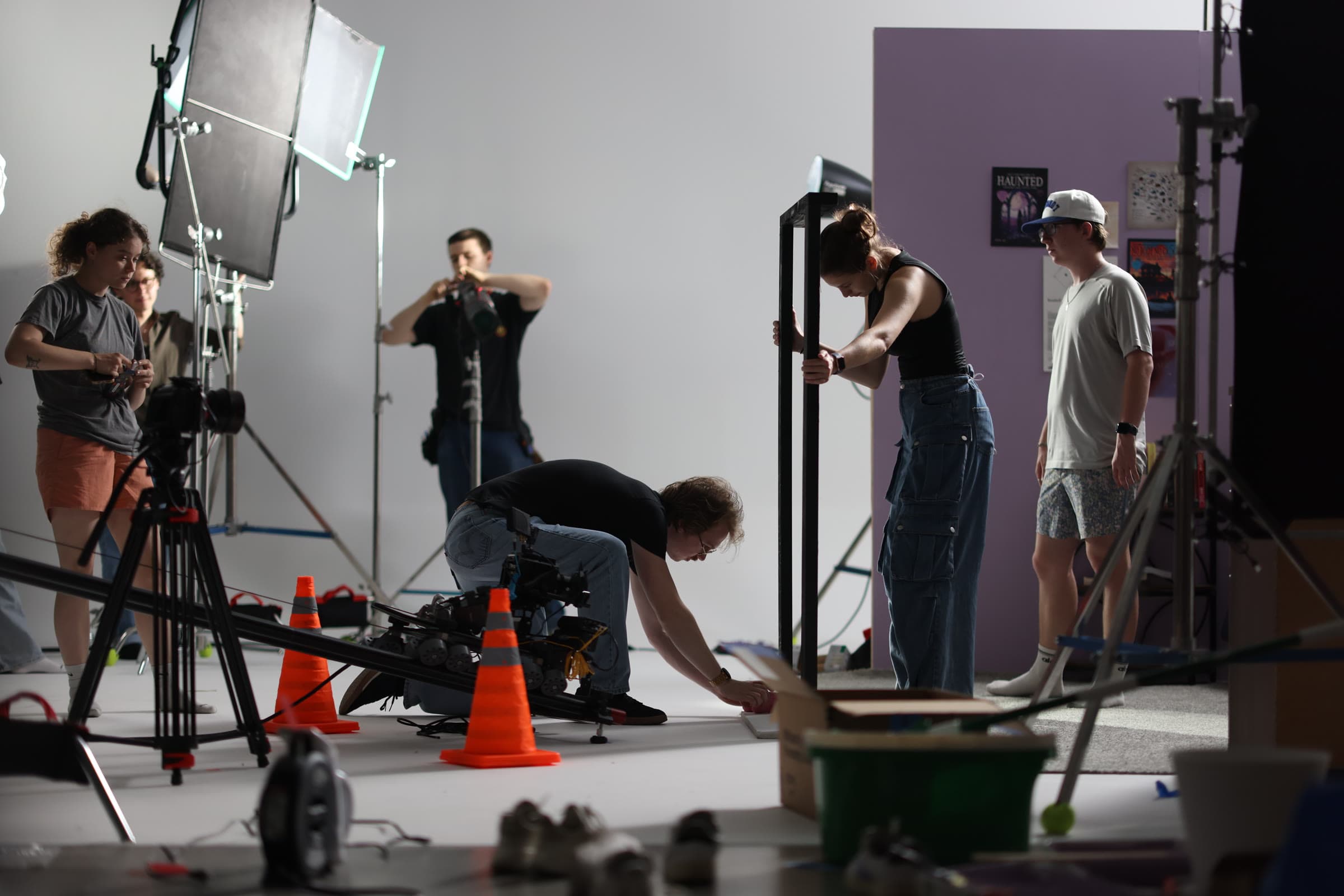 Behind the scenes on an AWOL set: a crew lines up a dolly shot in a studio